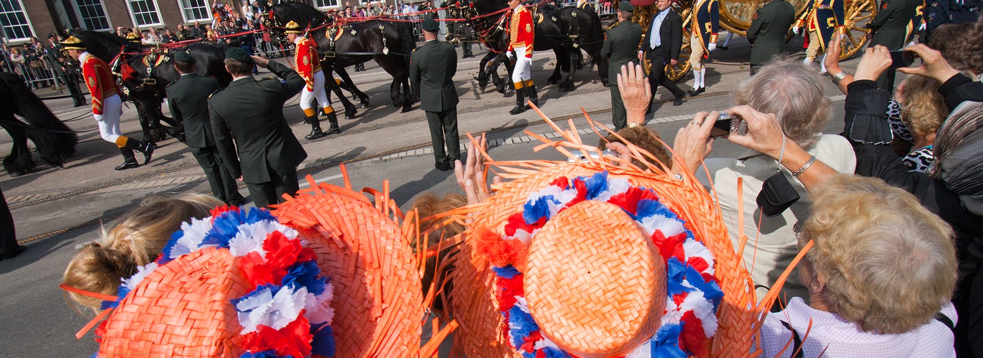 THE HAGUE, HOLLAND - SEPT 21: Dutch royal family in the golden coach waving to the public on Prinsjesdag (opening of parliamentary year by the Dutch queen). September 21, 2010 in The Hague, Holland.